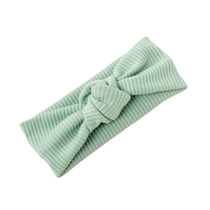Elastic mint green ribbed baby headband with a cross knot design on white background