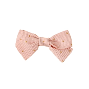 Roze corduroy haarstrik met gouden glittersterren op een witte achtergrond