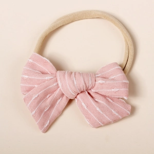 Close-up of pink striped bow with soft elastic nylon headband for babies and infants