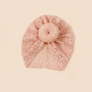 Detail of pink floral lace texture on newborn baby turban with donut knot style