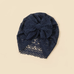 Navy blue lace baby turban hat featuring a large decorative floral bow and hollow mesh