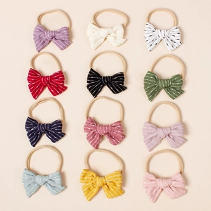 Set of 12 colorful striped bow nylon headbands for babies in neat 3x4 layout display
