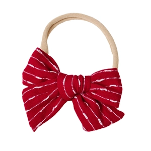 Soft nylon baby headband with a red striped bow featuring white stitching details