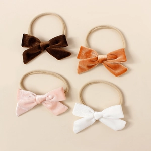 Lot de quatre bandeaux en velours pour bébé aux teintes marron, orange, rose et blanc