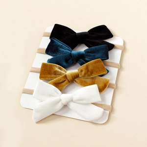 Lot de quatre bandeaux à nœuds en velours pour bébés en noir, bleu, jaune et blanc