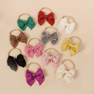 Lot de 11 bandeaux à nœuds en tissu coloré pour bébés filles disposés à plat