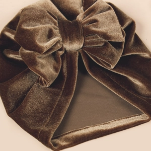 Dark coffee velvet baby turban hat with a large golden velvet bow for autumn and winter