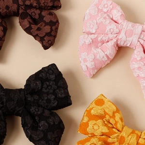 Fermagli a fiocco in tessuto jacquard floreale per bambine in nero, rosa e giallo