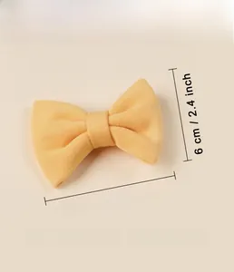 Detail showing faux cashmere yellow bow hair clip size 8.5 x 6 cm and weight 8.6g