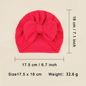 Detailed view of red baby turban hat with oversized bow showing 18x17.5cm dimensions