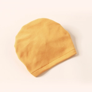 Ginger yellow knitted baby turban hat with cashmere-like texture and a bow design