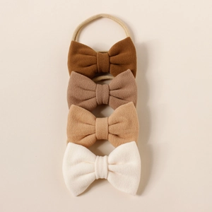 Set of four neutral earth-toned cashmere-style bow headbands for babies with nylon bands