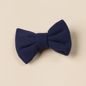 Close-up of deep blue faux cashmere bow hair clip with soft brushed fabric texture