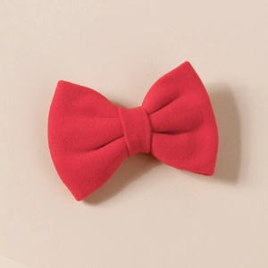 Detail of red faux cashmere bow hair clip for girls with a soft matte velvet texture