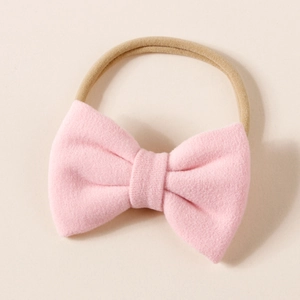 Detail of soft pink cashmere bow headband for infants with high elastic nylon band