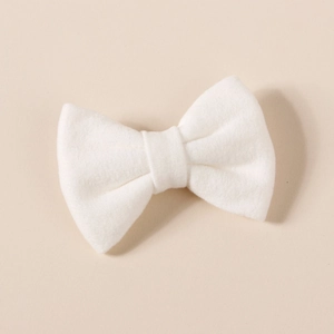 Detailed view of a soft white plush bow clip with fluffy texture for hair accessories