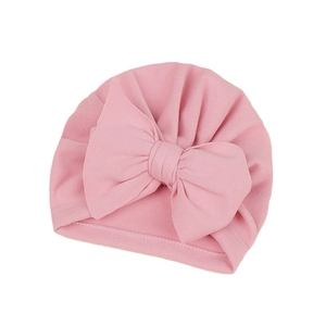 Soft pink newborn baby turban hat with a large bow detail for infants and toddlers