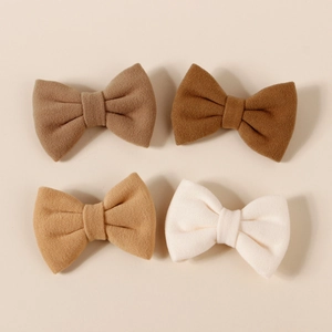 Set of four faux cashmere bow hair clips in earthy brown tones for girls