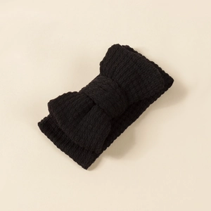 Detailed view of the black ribbed knit texture on this elastic baby bow headband