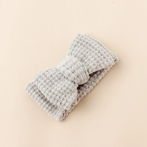 Detailed view of grey knitted baby headband showing soft waffle texture and large bow knot