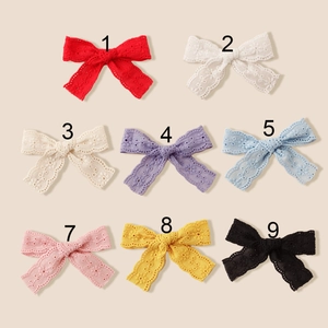 Macro shot of eight colors of embroidered lace butterfly hair clips for girls
