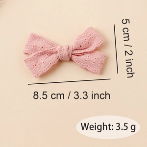 Detailed view of pink lace bow hair clip showing floral embroidery and size 8.5cm x 5cm