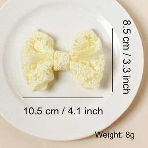 Detail view of yellow lace embroidered bow clip showing dimensions 10.5cm by 8.5cm