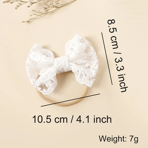 Detail view of baby lace bow headband with floral embroidery and soft nylon elastic band