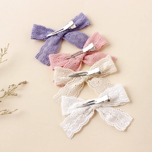 Set of four lace embroidered butterfly hair clips in purple, pink, beige and white