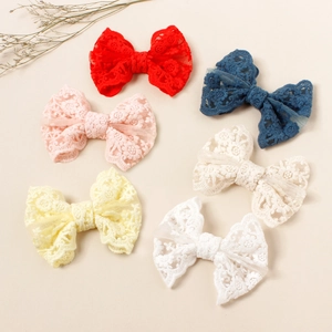 Close-up of set of six lace butterfly hair clips in red navy pink cream yellow and white
