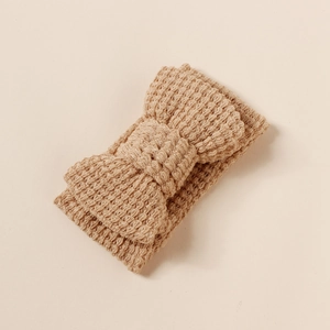 Close-up of knit baby headband showing soft waffle texture and large double bow design