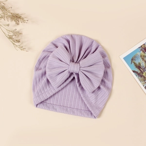 Detailed texture of lavender ribbed knit baby beanie with a large decorative bow