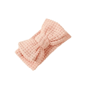 Pink knit baby headband featuring a large double-layered bow and soft waffle texture