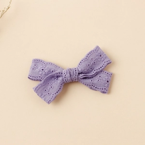 Close-up of purple lace embroidery butterfly hair clip with floral hollowed patterns