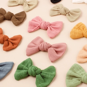 Detail showing various colors of waffle texture fabric bow hair clips for girls