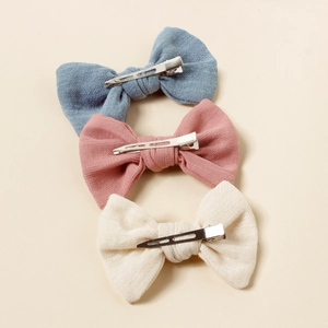 Three-piece bow hair clip set for girls in blue, pink, and cream textured cotton linen
