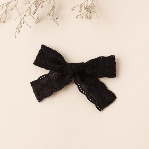 Detail of the elegant black lace butterfly bow hair clip with intricate floral patterns
