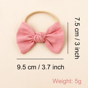 Detailed view of pink bow baby nylon headband with size dimensions and weight info