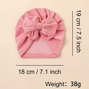 Detail showing pink and white striped baby turban hat with a large soft bow decoration