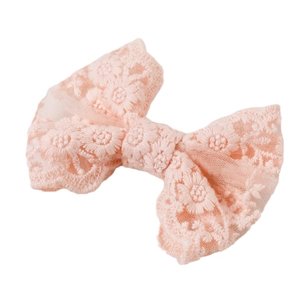 Pink embroidered lace bow hair clip for girls with delicate floral patterns on white background