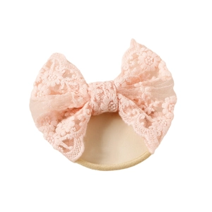 Delicate pink lace butterfly bow headband on soft nylon band for infant girls