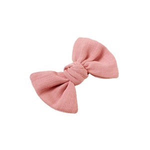 Pink fabric bow hair clip with ribbed texture for girls in a minimalist candy series style
