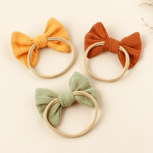 Set of 3 nylon baby bow headbands in mustard yellow, caramel orange and dusty green