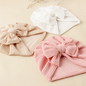 Three-piece set of baby bow turban hats in white, beige, and pink ribbed knit fabric