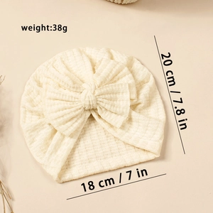 Détail du bonnet turban crème pour bébé avec dimensions et poids du produit de 38g