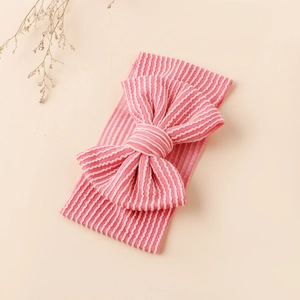 Détail du bandeau bébé à rayures roses et blanches avec un grand double nœud en maille