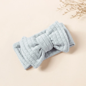 Detail of light blue waffle knit fabric and large double layered bow on baby headband