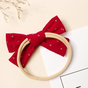 Bandeau bébé avec nœud en velours côtelé rouge, étoiles argentées et nylon extensible