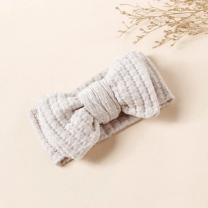 Close-up of oatmeal waffle knit double layered bow headband for babies and kids