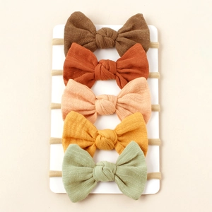 Five-pack set of elastic nylon baby headbands with soft textured fabric bows in Morandi colors